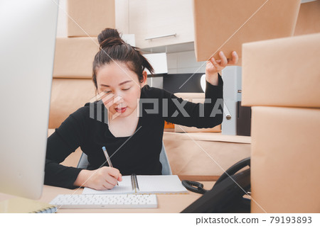 Asian beautiful woman Receiving order notebooks in selling products online, Working at home the technology to buy and sell of online, preparing products for delivery to customers 79193893