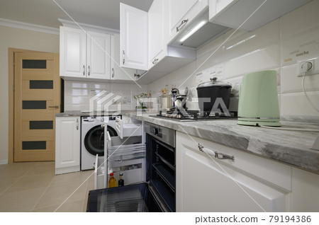 Luxury white modern kitchen furniture with doors open Luxury white modern kitchen furniture with doors open 79194386
