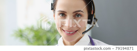 Portrait of doctor operator in headphones for remote work Portrait of doctor operator in headphones for remote work 79194871