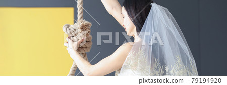 Woman in wedding dress holds her hand on loop for neck 79194920