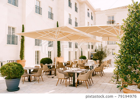 Street cafe under sun umbrellas in Perast, Montenegro. Street cafe under sun umbrellas in Perast, Montenegro. 79194976