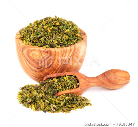 Dried green paprika flakes with seeds in olive bowl and scoop, isolated on white background. Chopped jalapeno, habanero or chilli pepper. Spices and herbs. Dried green paprika flakes with seeds in olive bowl and scoop, isolated on white background. Chopped jalapeno, habanero or chilli pepper. Spices and herbs. 79195347