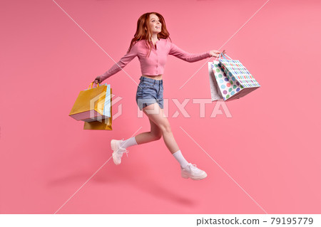 Excited trendy stylish carefree woman rejoicing with sales, shopping time, isolated 79195779