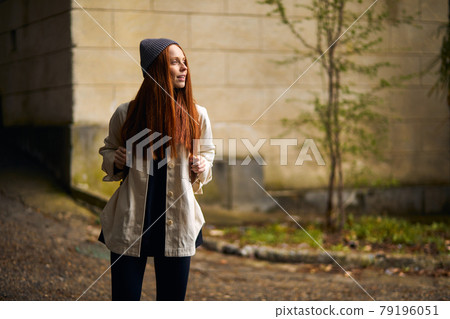 Adorable caucasian female Traveler with backpack walking in historical site Adorable caucasian female Traveler with backpack walking in historical site 79196051