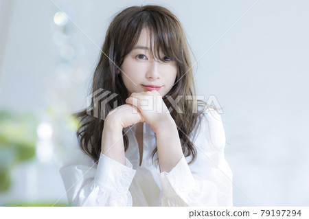 A woman by the window A woman by the window 79197294