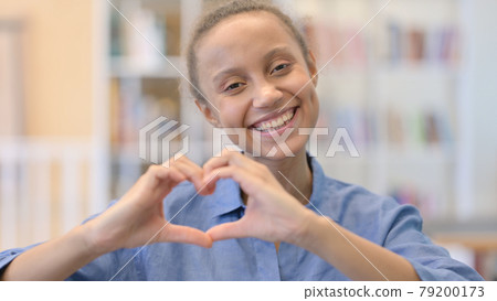 Portrait of African Woman showing Heart Sign with Hands 79200173