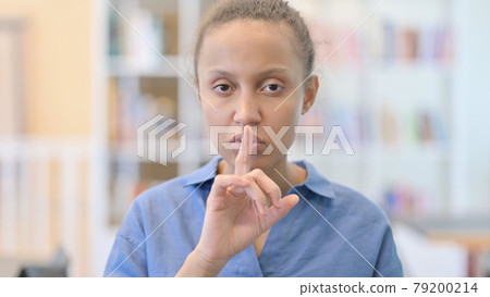 Portrait of African Woman Putting Finger on Lips, Quiet Sign 79200214