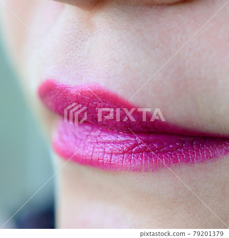 Close up shot of woman lips with glossy fuchsia lipstick Close up shot of woman lips with glossy fuchsia lipstick 79201379