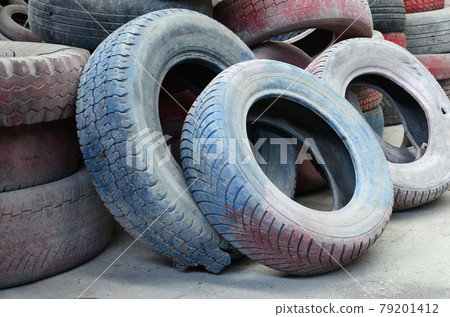 A picture of many old used tires left on a waste dump A picture of many old used tires left on a waste dump 79201412