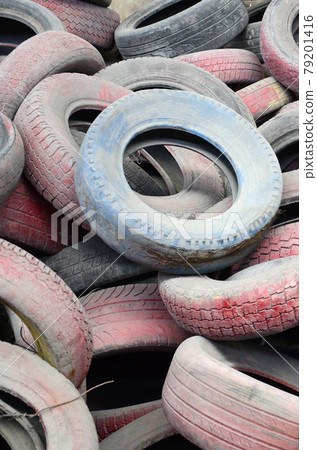 A picture of many old used tires left on a waste dump 79201416