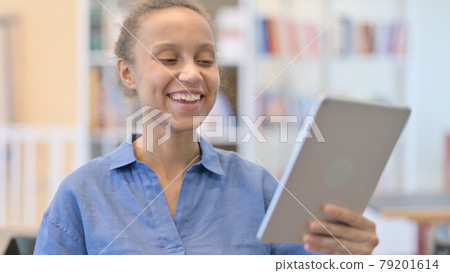 Portrait of African Woman doing Video Call on Tablet 79201614