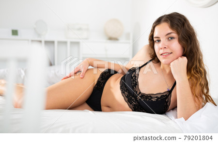 Sexy woman with long hair in underwear lying on bed Sexy woman with long hair in underwear lying on bed 79201804