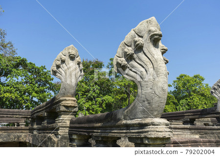 Seven Headed Naga Sculptures under Vivid Blue Sky at the Entrance of Phimai Historical Park in Nakhon Ratchasima, Thailand. Seven Headed Naga Sculptures under Vivid Blue Sky at the Entrance of Phimai Historical Park in Nakhon Ratchasima, Thailand. 79202004