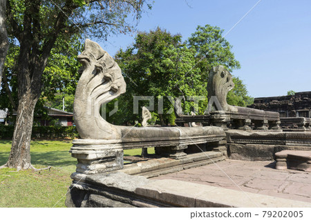 Seven Headed Naga Sculptures under Vivid Blue Sky at the Entrance of Phimai Historical Park in Nakhon Ratchasima, Thailand. Seven Headed Naga Sculptures under Vivid Blue Sky at the Entrance of Phimai Historical Park in Nakhon Ratchasima, Thailand. 79202005