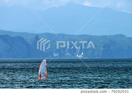 Windsurfing off the coast of Shioya in sunny weather in Otaru, Hokkaido. Windsurfing off the coast of Shioya in sunny weather in Otaru, Hokkaido. 79202031