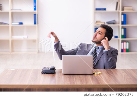 Young handsome businessman employee working in the office Young handsome businessman employee working in the office 79202373