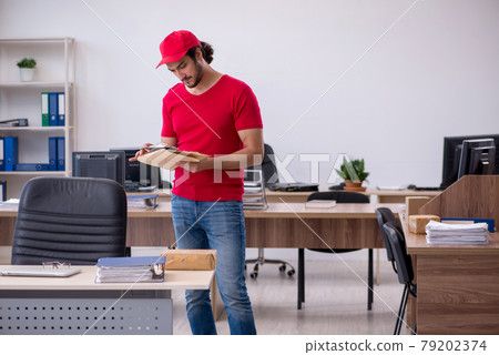 Young male courier delivering post to the office Young male courier delivering post to the office 79202374