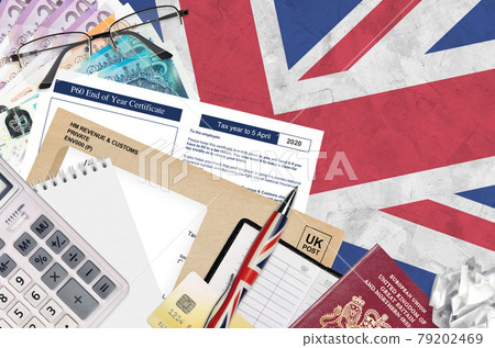English Tax form P60 End of year certificate by HM revenue and customs lies on table with office items. HMRC paperwork and tax paying process in United Kingdom English Tax form P60 End of year certificate by HM revenue and customs lies on table with office items. HMRC paperwork and tax paying process in United Kingdom 79202469