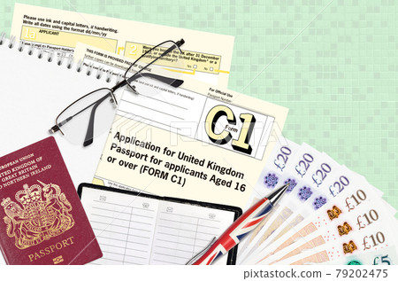 English form C1 Application for United Kingdom passport for applicants aged 16 or over lies on table with office items. UK passport paperwork English form C1 Application for United Kingdom passport for applicants aged 16 or over lies on table with office items. UK passport paperwork 79202475