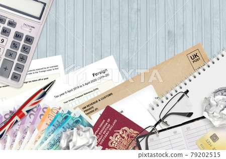 English Tax form sa106 Foreign from HM revenue and customs lies on table with office items. HMRC paperwork and tax paying process in United Kingdom English Tax form sa106 Foreign from HM revenue and customs lies on table with office items. HMRC paperwork and tax paying process in United Kingdom 79202515