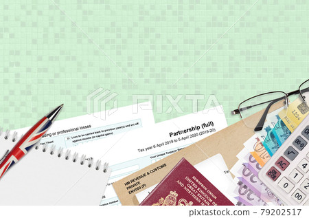 English Tax form sa104 Partnership from HM revenue and customs lies on table with office items. HMRC paperwork and tax paying process in United Kingdom English Tax form sa104 Partnership from HM revenue and customs lies on table with office items. HMRC paperwork and tax paying process in United Kingdom 79202517