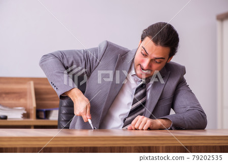 Young businessman employee sitting in the office Young businessman employee sitting in the office 79202535