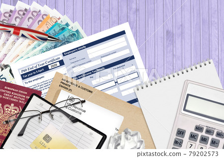 English Tax form P60 End of year certificate by HM revenue and customs lies on table with office items. HMRC paperwork and tax paying process in United Kingdom English Tax form P60 End of year certificate by HM revenue and customs lies on table with office items. HMRC paperwork and tax paying process in United Kingdom 79202573