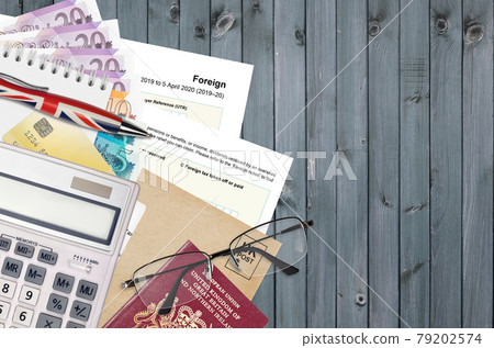 English Tax form sa106 Foreign from HM revenue and customs lies on table with office items. HMRC paperwork and tax paying process in United Kingdom English Tax form sa106 Foreign from HM revenue and customs lies on table with office items. HMRC paperwork and tax paying process in United Kingdom 79202574