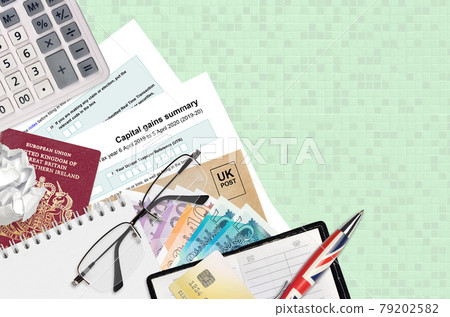 English Tax form sa107 Capital gains summary from HM revenue and customs lies on table with office items. HMRC paperwork and tax paying process in United Kingdom English Tax form sa107 Capital gains summary from HM revenue and customs lies on table with office items. HMRC paperwork and tax paying process in United Kingdom 79202582