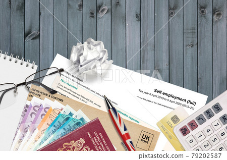 English Tax form sa103 Self-employment from HM revenue and customs lies on table with office items. HMRC paperwork and tax paying process in United Kingdom English Tax form sa103 Self-employment from HM revenue and customs lies on table with office items. HMRC paperwork and tax paying process in United Kingdom 79202587