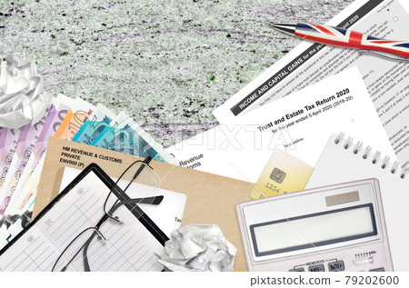 English Tax form sa900 Trust and estate tax return 2020 from HM revenue and customs lies on table with office items. HMRC paperwork and tax paying process in United Kingdom English Tax form sa900 Trust and estate tax return 2020 from HM revenue and customs lies on table with office items. HMRC paperwork and tax paying process in United Kingdom 79202600