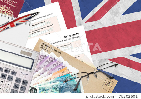 English Tax form sa105 UK Property from HM revenue and customs lies on table with office items. HMRC paperwork and tax paying process in United Kingdom English Tax form sa105 UK Property from HM revenue and customs lies on table with office items. HMRC paperwork and tax paying process in United Kingdom 79202601