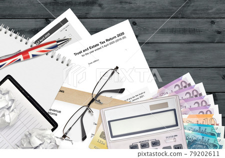 English Tax form sa900 Trust and estate tax return 2020 from HM revenue and customs lies on table with office items. HMRC paperwork and tax paying process in United Kingdom English Tax form sa900 Trust and estate tax return 2020 from HM revenue and customs lies on table with office items. HMRC paperwork and tax paying process in United Kingdom 79202611