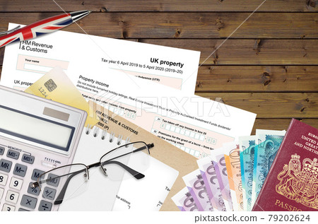 English Tax form sa105 UK Property from HM revenue and customs lies on table with office items. HMRC paperwork and tax paying process in United Kingdom English Tax form sa105 UK Property from HM revenue and customs lies on table with office items. HMRC paperwork and tax paying process in United Kingdom 79202624