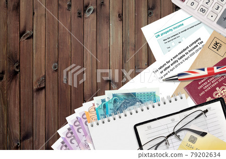 English form sa700 Tax return for a non-resident company or other entity liable to income tax from HM revenue and customs lies on table with office items. HMRC paperwork English form sa700 Tax return for a non-resident company or other entity liable to income tax from HM revenue and customs lies on table with office items. HMRC paperwork 79202634
