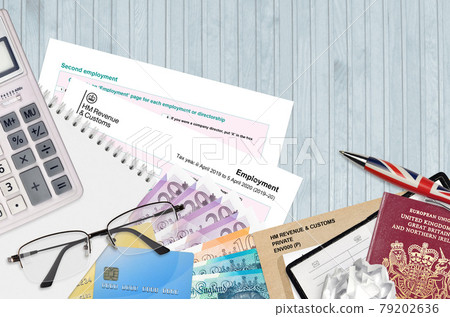 English Tax form sa102 Employment by HM revenue and customs lies on table with office items. HMRC paperwork and tax paying process in United Kingdom English Tax form sa102 Employment by HM revenue and customs lies on table with office items. HMRC paperwork and tax paying process in United Kingdom 79202636