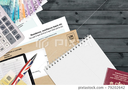 English Tax form sa108 Residence remittance basis etc from HM revenue and customs lies on table with office items. HMRC paperwork and tax paying process in United Kingdom English Tax form sa108 Residence remittance basis etc from HM revenue and customs lies on table with office items. HMRC paperwork and tax paying process in United Kingdom 79202642