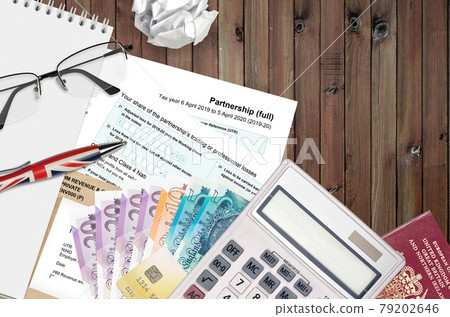 English Tax form sa104 Partnership from HM revenue and customs lies on table with office items. HMRC paperwork and tax paying process in United Kingdom English Tax form sa104 Partnership from HM revenue and customs lies on table with office items. HMRC paperwork and tax paying process in United Kingdom 79202646