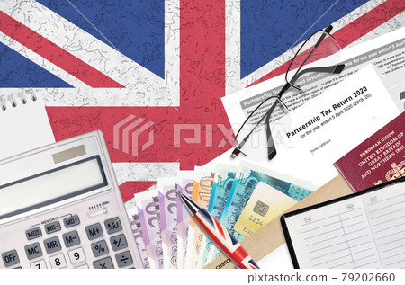 English Tax form sa800 Partnership tax return 2020 from HM revenue and customs lies on table with office items. HMRC paperwork and tax paying process in United Kingdom English Tax form sa800 Partnership tax return 2020 from HM revenue and customs lies on table with office items. HMRC paperwork and tax paying process in United Kingdom 79202660