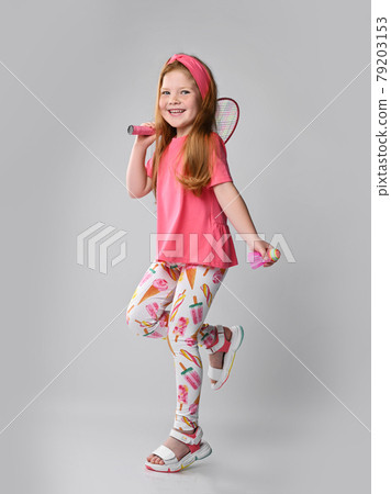 Happy redhead kid girl in pink t-shirt, colorful Happy redhead kid girl in pink t-shirt, colorful 79203153