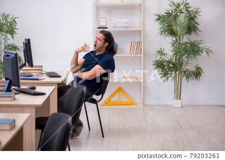 Young male student being tired during exam preparation Young male student being tired during exam preparation 79203261
