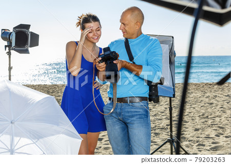 Photographer working on sea beach 79203263