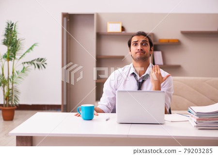 Young male employee working from home during pandemic Young male employee working from home during pandemic 79203285