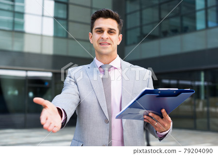 Successful businessman ready for handshake Successful businessman ready for handshake 79204090