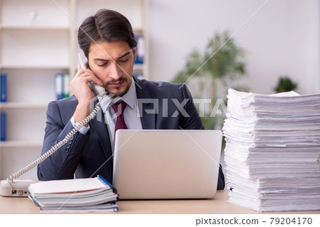 Young male employee working in the office 79204170