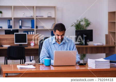 Young male employee working in the office Young male employee working in the office 79204418