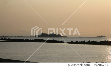 A large passenger ship sails in the Sea of Japan, which is dyed in sepia at dusk 79206787