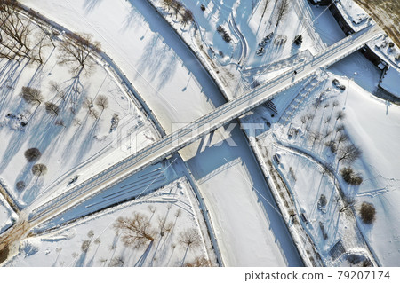 Top view of the pedestrian bridge over the frozen Svisloch river in Minsk. Belarus Top view of the pedestrian bridge over the frozen Svisloch river in Minsk. Belarus 79207174