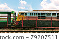 Rear  train and bogie with Chain Link fence in the yard of the urban station 79207511