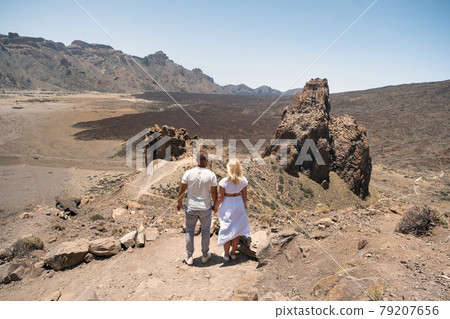A couple in love hold hands in the crater of the Teide volcano.Tenerife, Canary Islands A couple in love hold hands in the crater of the Teide volcano.Tenerife, Canary Islands 79207656